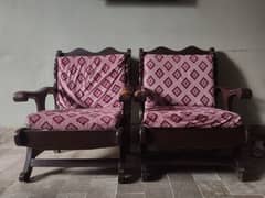 two wooden sofas