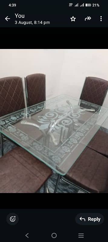 A glass dining table with 6 chairs 1