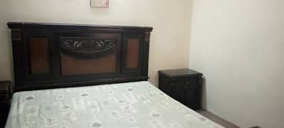 double bed with metres and side tables and dressing