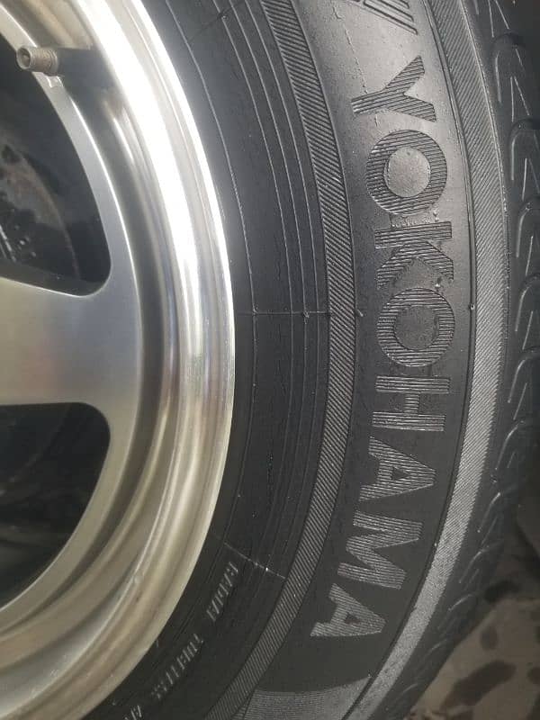 195~65~15 Yokohama bluearth 4 tires  along with 15 inch rims 1