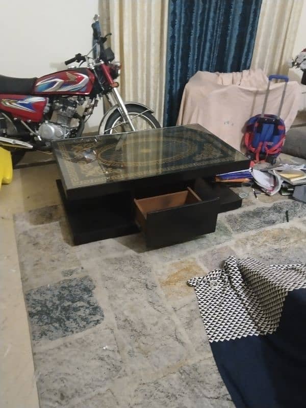 A black wooden table,with golden design on it! 1