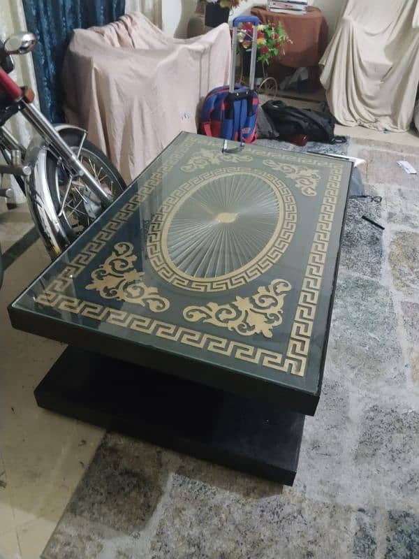 A black wooden table,with golden design on it! 2