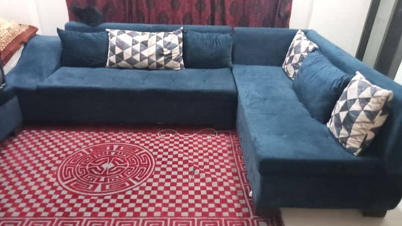 L shaped slightly used Sofa set with table and puffy. 0