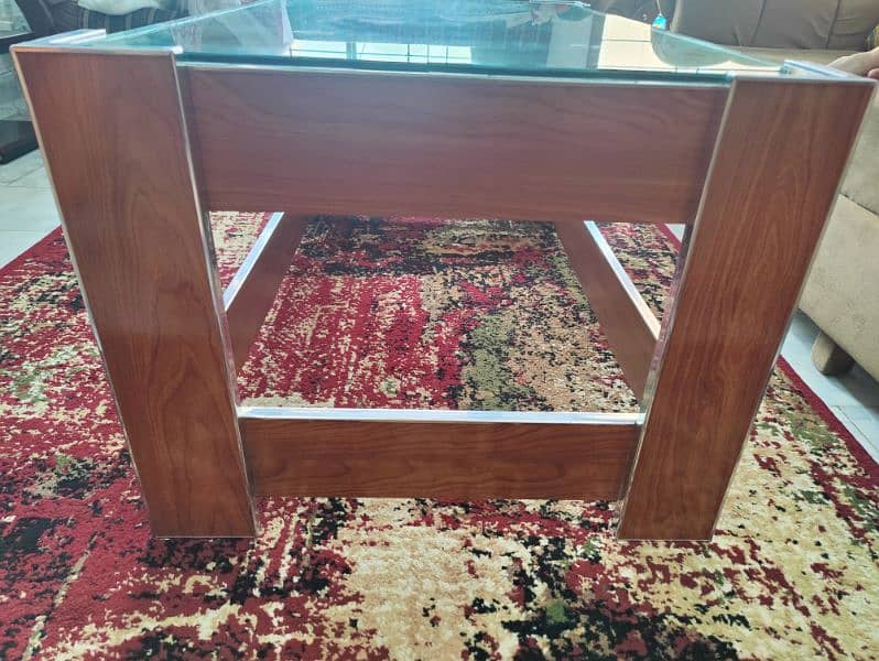 Wooden table with fully centre glass. . . 1