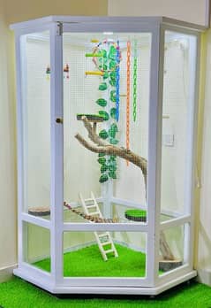 A gorgeous white fully decorated bird cage with a touch of nature.