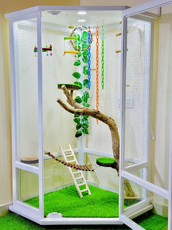 A gorgeous white fully decorated bird cage with a touch of nature. 1