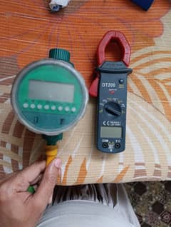 Clamp meter and automatic timer device for gardening water