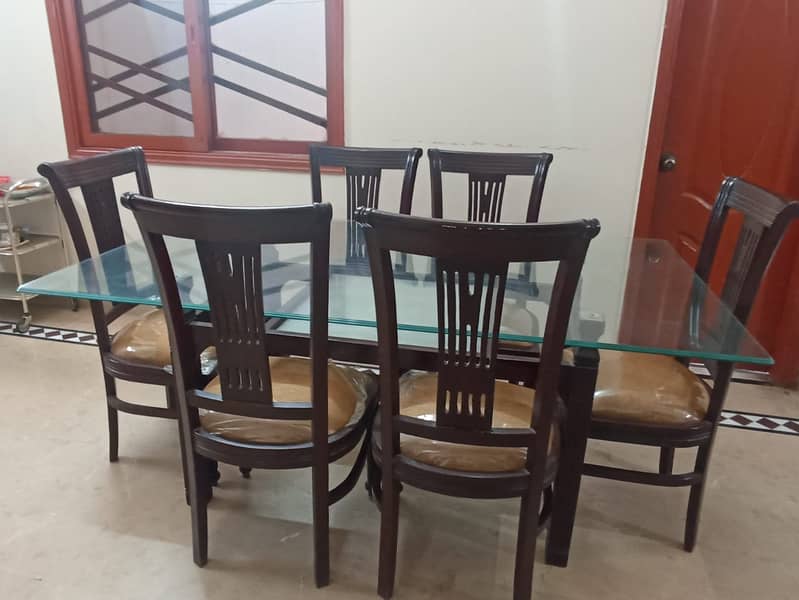 Wooden table (6 chairs) with glass top. 0