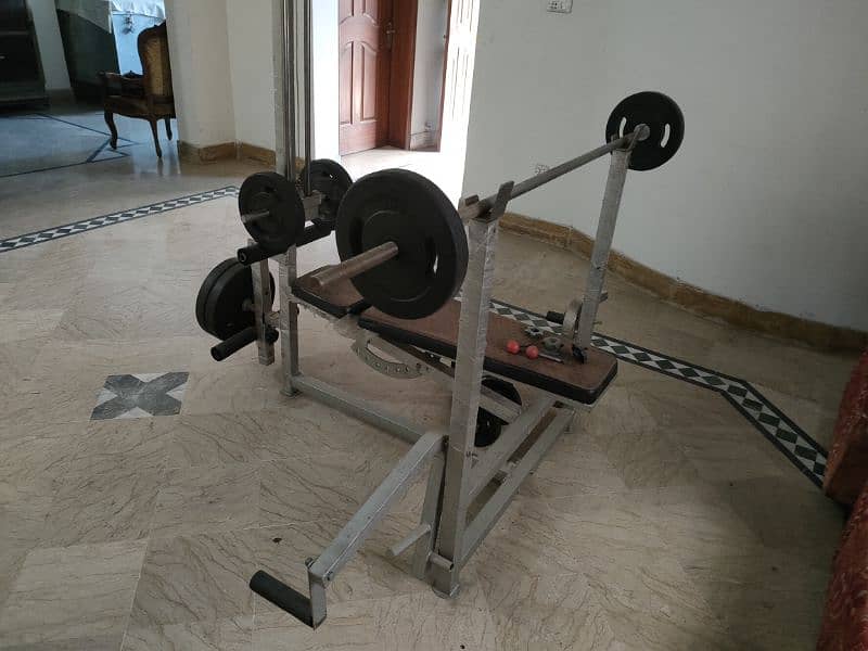 home gym equipment weight plates and bench press 0