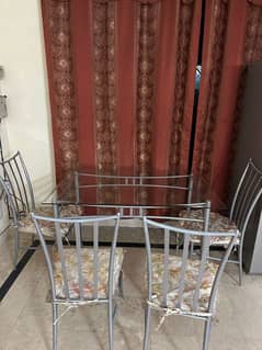 Glass table and 4 metal chairs