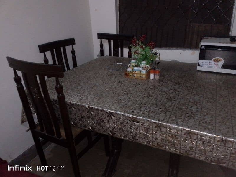 A dining table with six chair and this table is glass 1