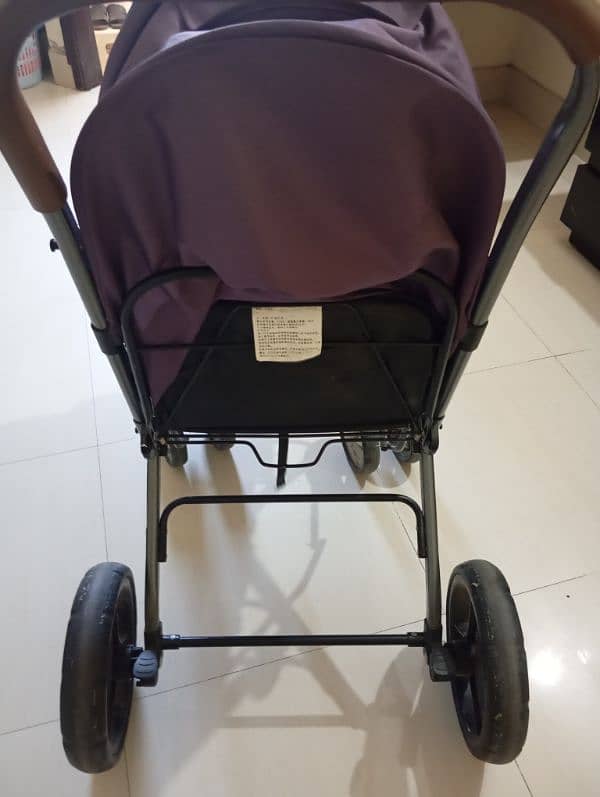 purple colored used pram 0