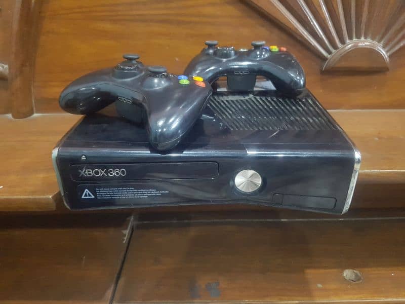 x box 360 slim model and 2 wire less controllers 1