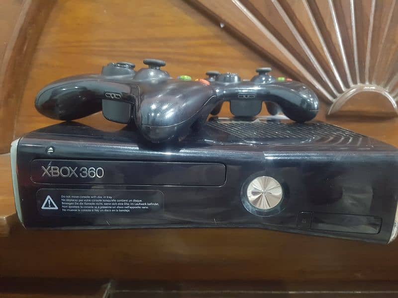 x box 360 slim model and 2 wire less controllers 2