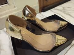 Branded golden heels