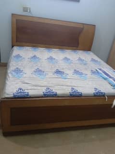 wooden bed along with Mattress