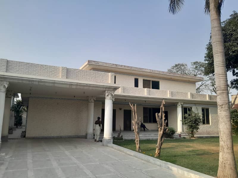 2 Kanal Double Unit House on Rent on Main Airport Road Phase 1 DHA Lahore . big lawn & Garden and parking 9