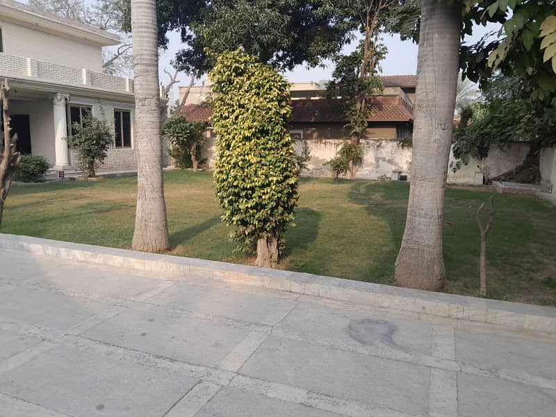 2 Kanal Double Unit House on Rent on Main Airport Road Phase 1 DHA Lahore . big lawn & Garden and parking 15