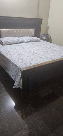 bed with mattress and dining table. . .