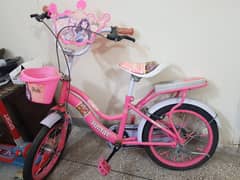 18-inch Barbie bicycle with a front basket and a rear seat, ideal for
                                title=