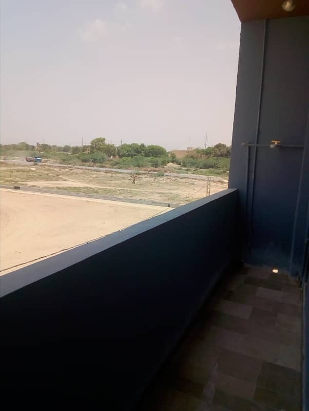 tow shops plus tow flats 90 yards commercial building foot ball ground facing block-2 saadi town 7