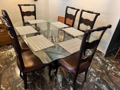 6 seater leather Made seats dining table good condition with 12 m glas