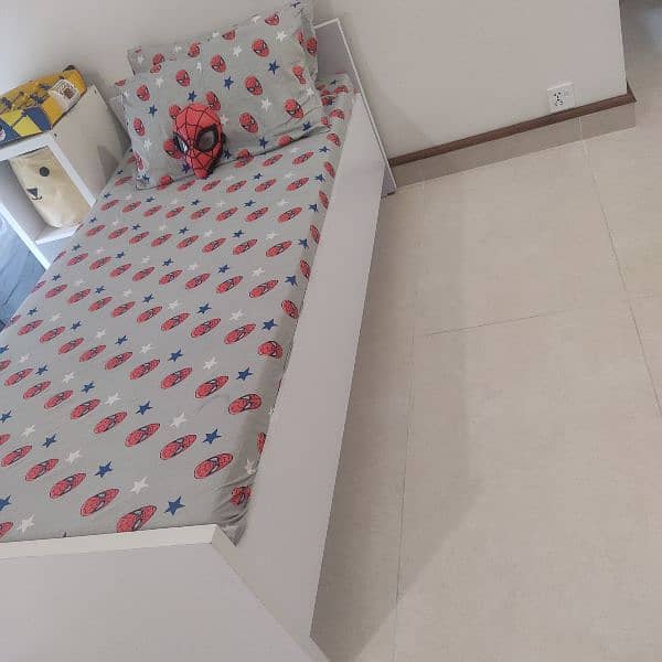 2 single kids size beds in white colour 1