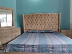 double bed with side tables and dressing