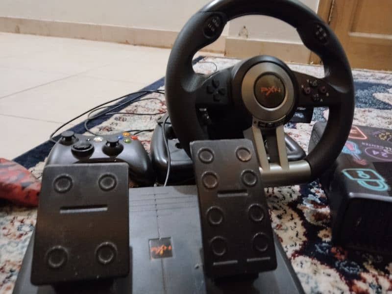 Xbox with steering wheel and 2 controllers 2