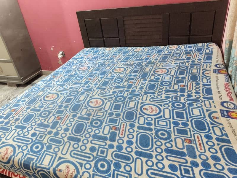 King size wooden bed with molty mattress. good condition. 2