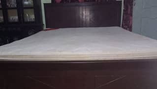 double bed with mattress and side tables