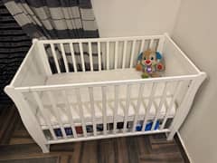 wooden cot with mattress