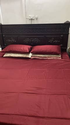 king size bed with two side tables and dressing table