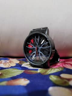 Man,s watch with car wheel rim hub design