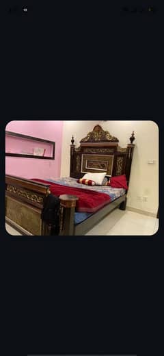 wooden double bed with side tables and dressing table and a mattress.