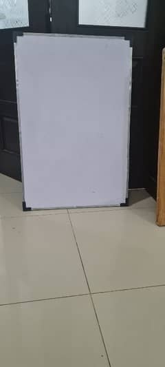 A white board and a carrem board in brand new condition