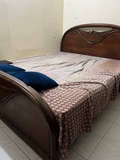 double bed with mattress and side tables