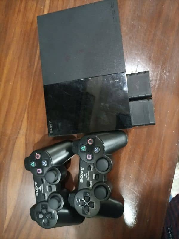 PS2, 2 wireless controller , memory card , games cd 2