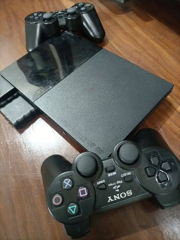 PS2, 2 wireless controller , memory card , games cd 3