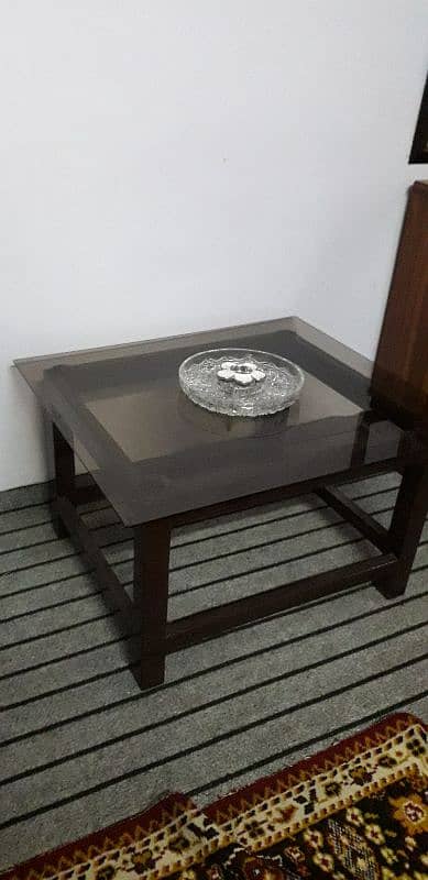 wooden and glass center table . 0