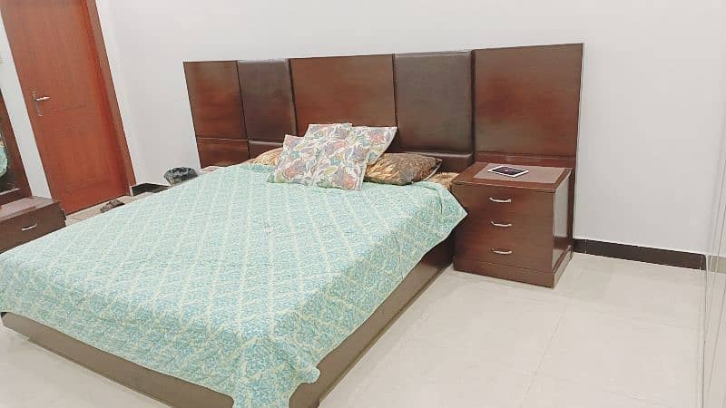 king size heavy down bed with two side tables and dressing 1