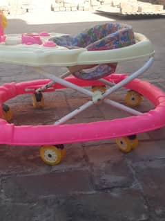 Kids walker (used) nice condition with 2 extra wheels.