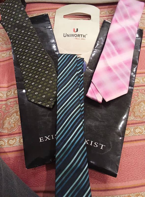 A bunch of men ties of different brands  Exist- Uniworth- Figure peeru 7