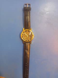 black and goldan watch