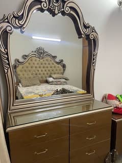 bed with two side tables and dressing table