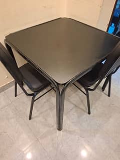 square dinning table with four chairs