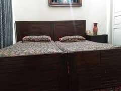 set of single beds with side table