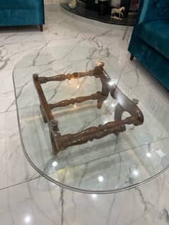 Carved wooden base with large round glasstop