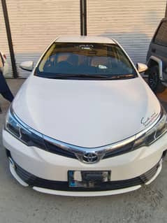 White Toyota Corolla Altis