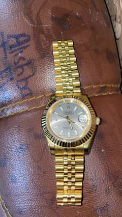 golden watch in steal body